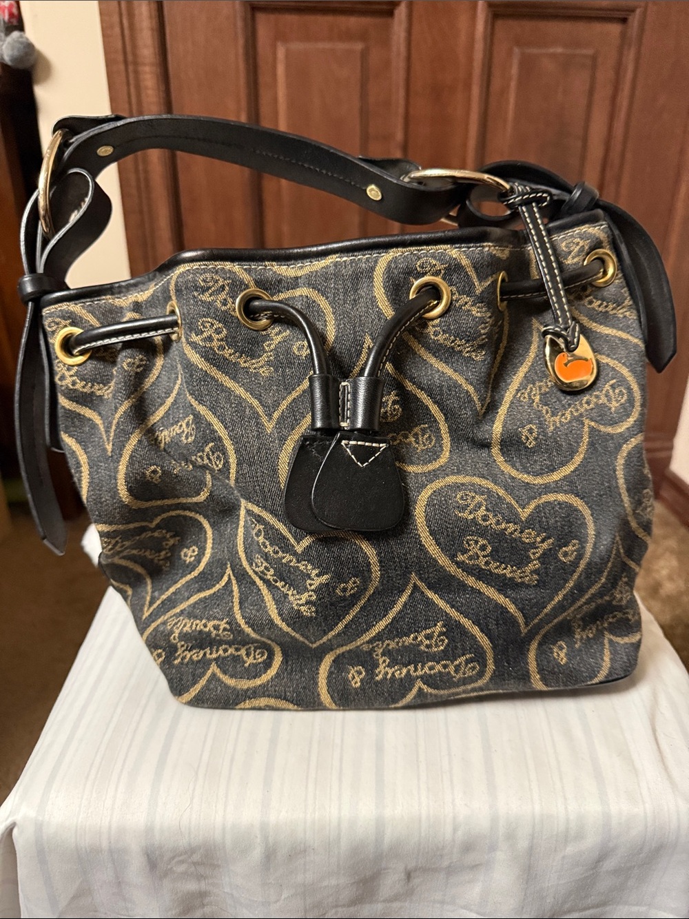 Dooney & Bourke Black and Gold Heart-Print Drawstring Shoulder Bag